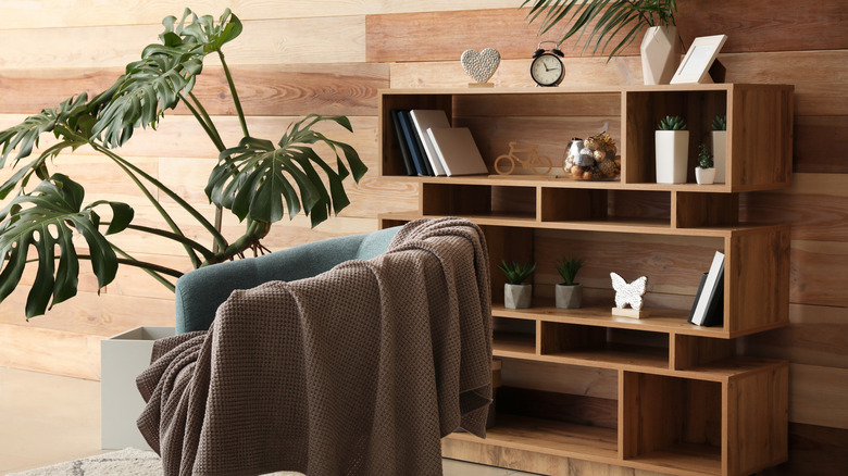 Interior with bookshelf holding books, trinkets, and plants