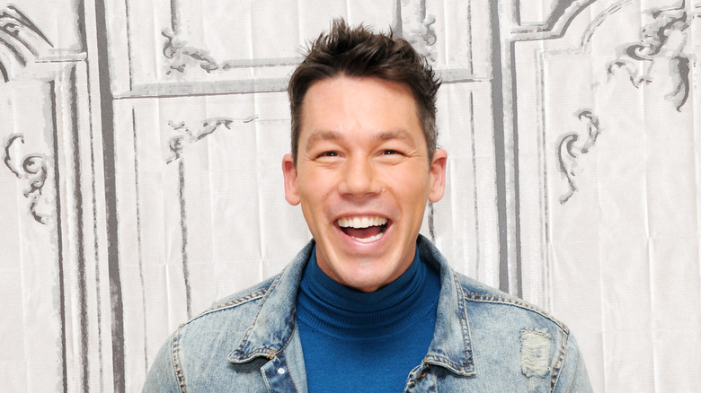 David Bromstad laughing with a jean jacket.