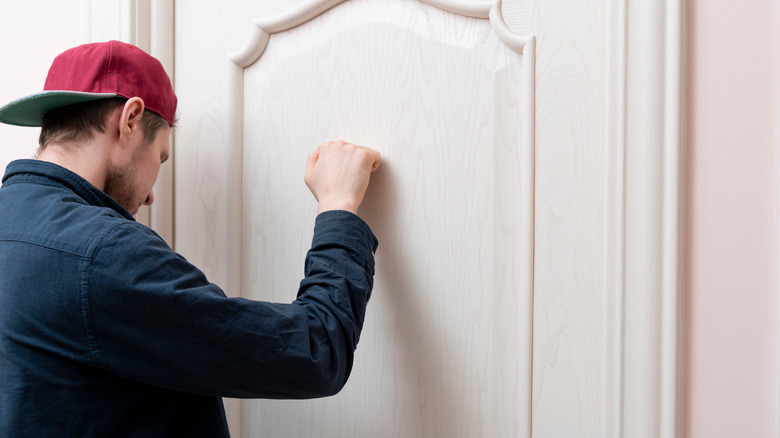 man knocking on door