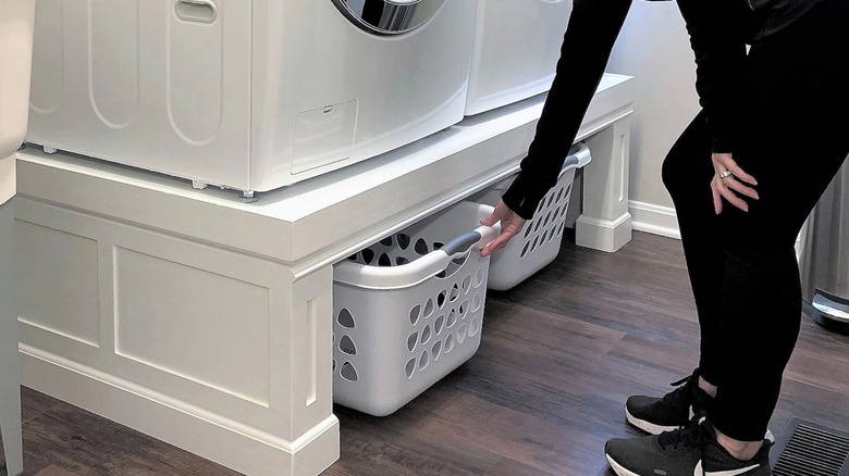 organized laundry room with pedestal