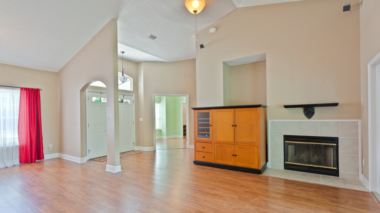 large, unfurnished, open concept living room and front entryway