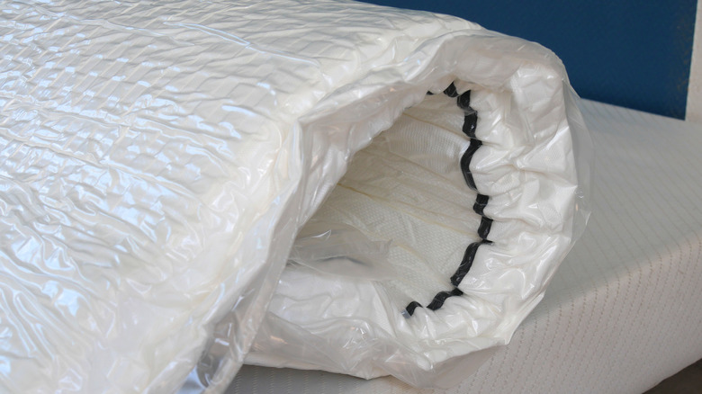 Vacuum-rolled mattress on a box spring