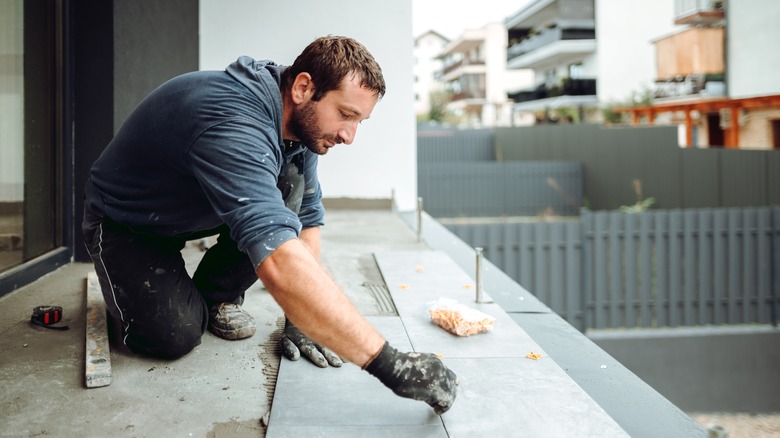 man laying tile