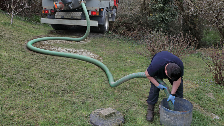 A man cleaning out a septic tank