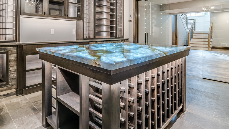 A wine bar counter with a backlit onyx surface