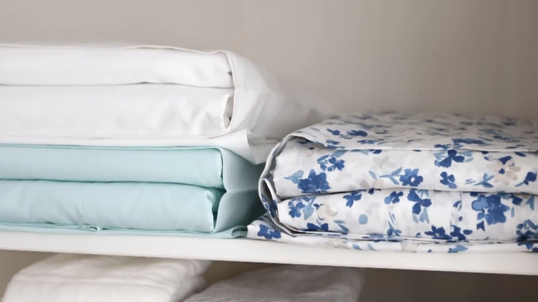 Sheet sets stored inside pillowcases on a shelf