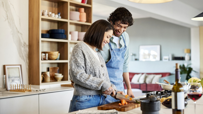 A happy couple preparing dinner together
