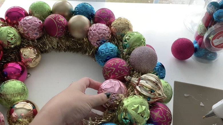 Crafting a bright ornament wreath using a glue gun