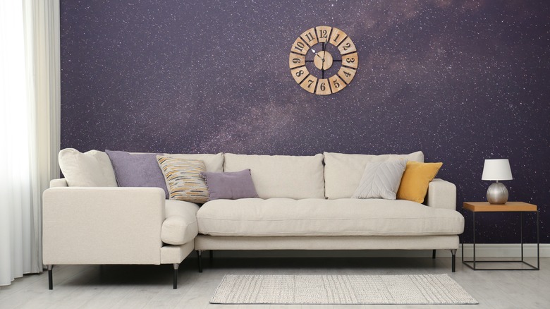 A living room with a starry studded sky wallpaper