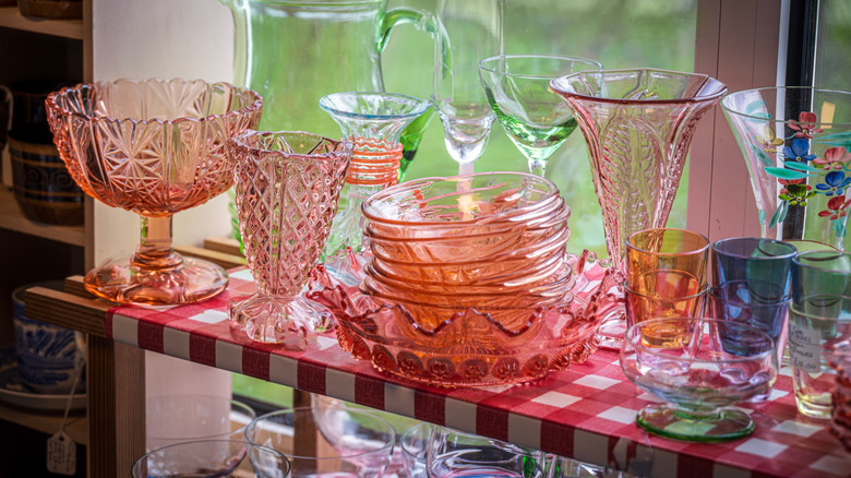 colorful Depression glass stacked on a shelf