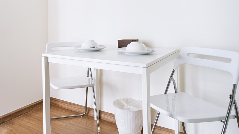 Folding chairs and small table inside