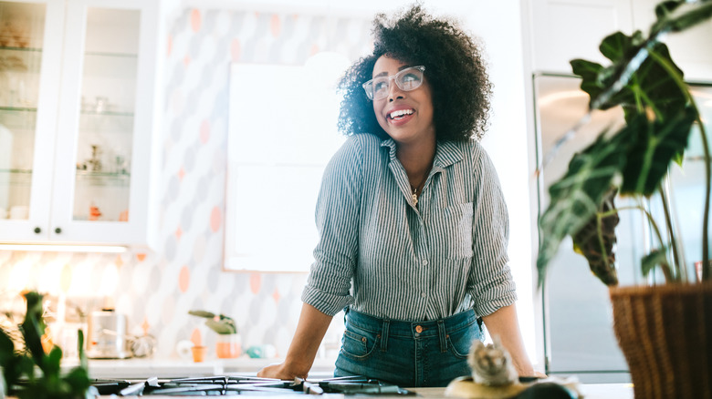 Woman smiling in sunny kitchen