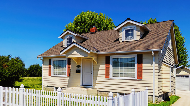 One story house with white picket fence outside