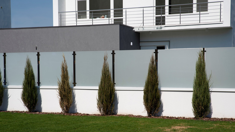 Home with frosted laminated glass fence in front yard