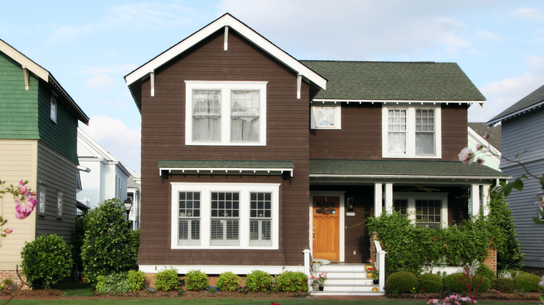 House with dark brown exterior paint, green roof