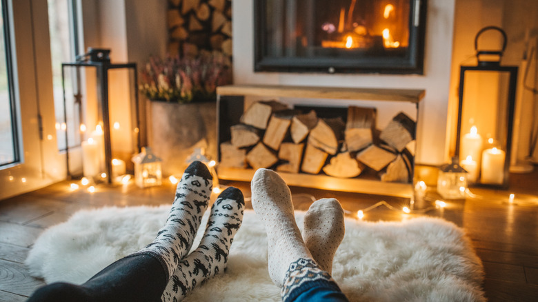 people sitting before a fireplace