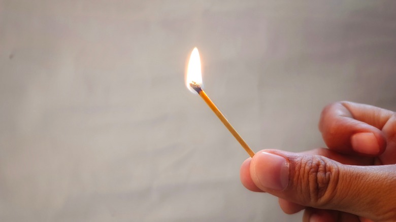 Lit match stick