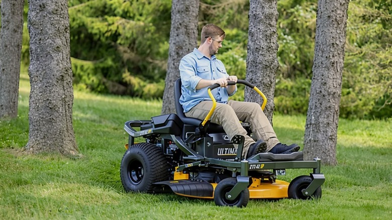 A person using a Cub Cadet ZT1 42 in. Gas Zero-Turn Mower on grass