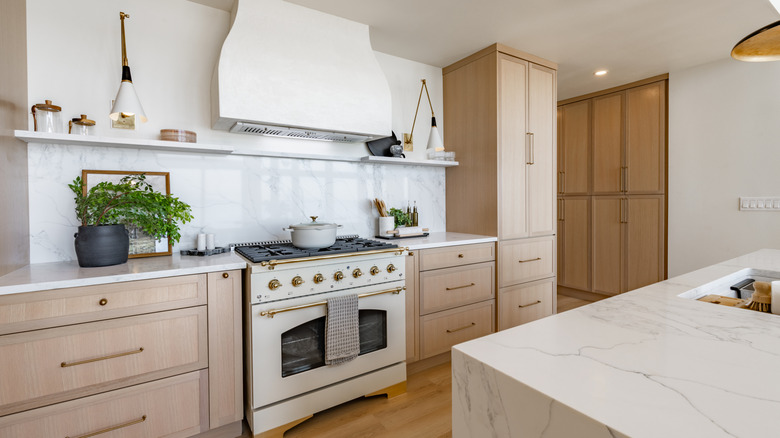 A neutral-colored kitchen with a large oven and stove