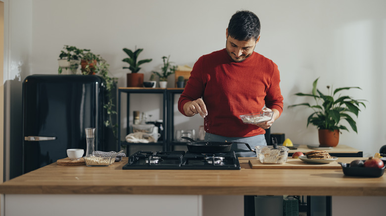 man cooking on stove