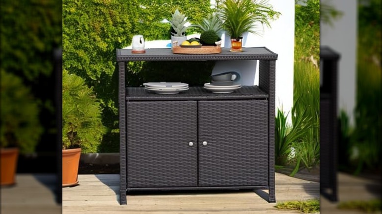 A Grand Patio outdoor wicker storage cabinet on a deck