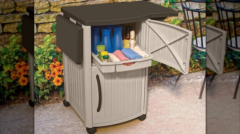 A Suncast outdoor patio grill prep station cart on a patio