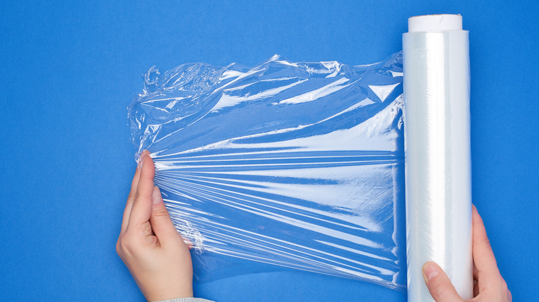 Person holding plastic wrap