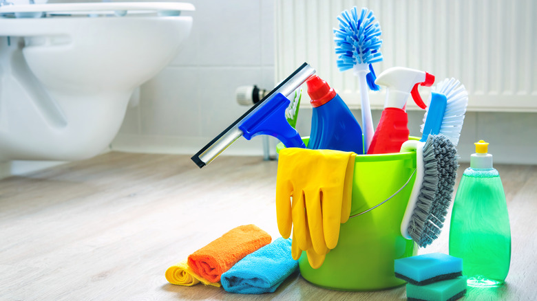 Cleaning supplies on bathroom floor