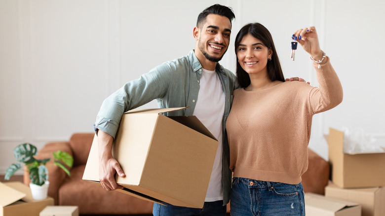 young couple holding keys