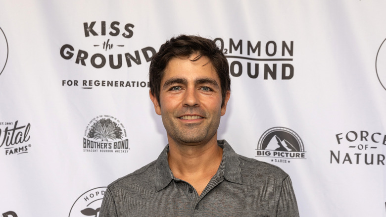 Adrian Grenier poses at film premiere
