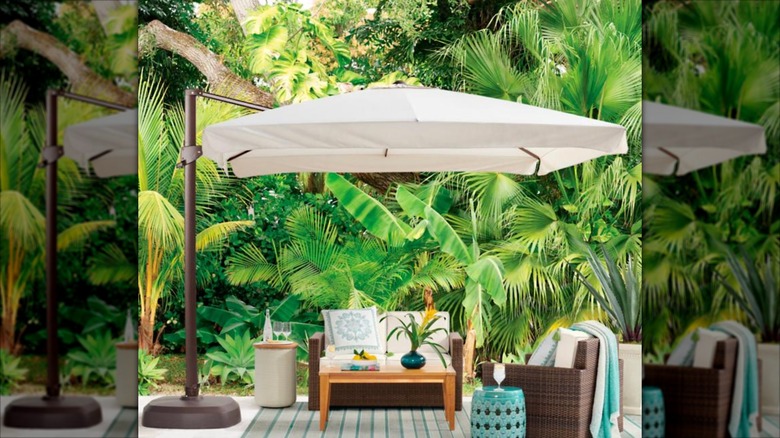 Frontgate white side mount yard umbrella with adjustable base on a patio