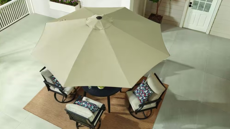 Hampton bay simple tan patio umbrella over a table