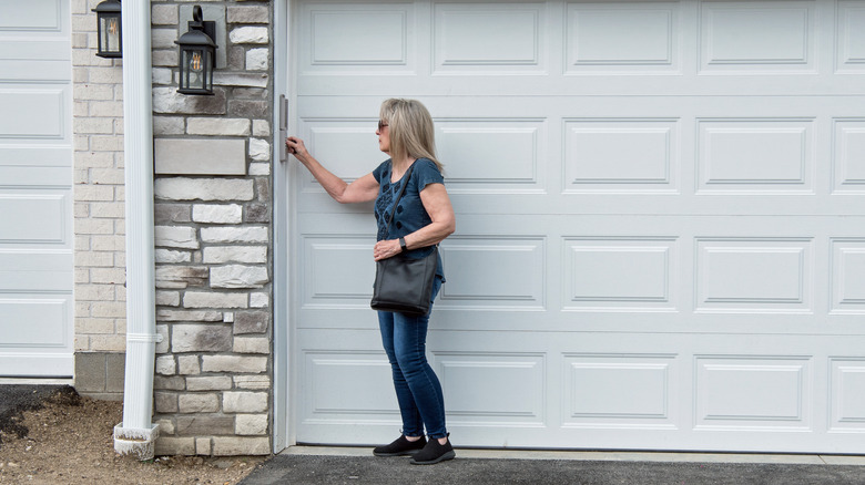 A woman entering a code into a garage door opener keypad