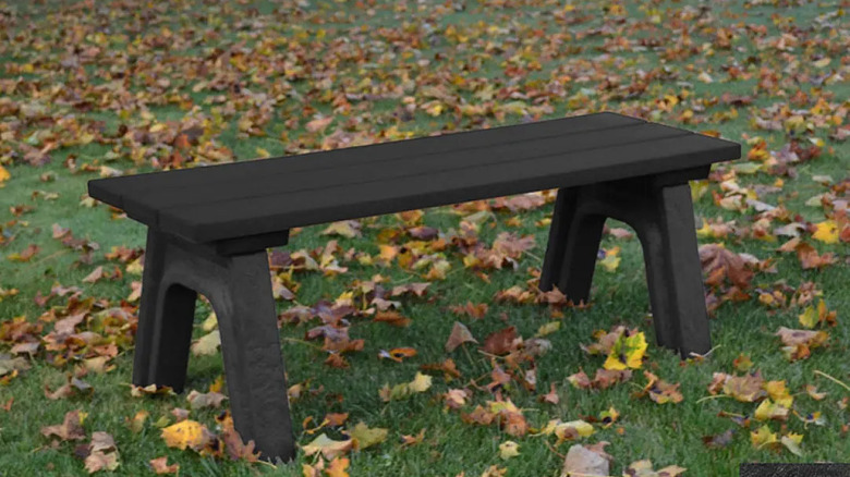 Recycled plastic light wood picnic table on outdoor deck