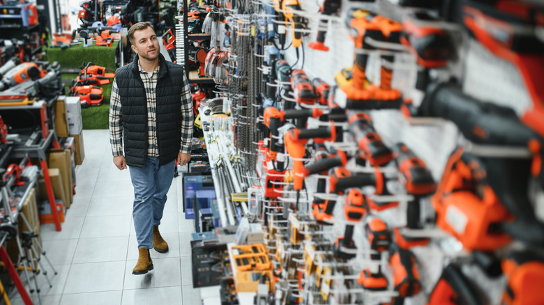 A man shopping for power tools in a store