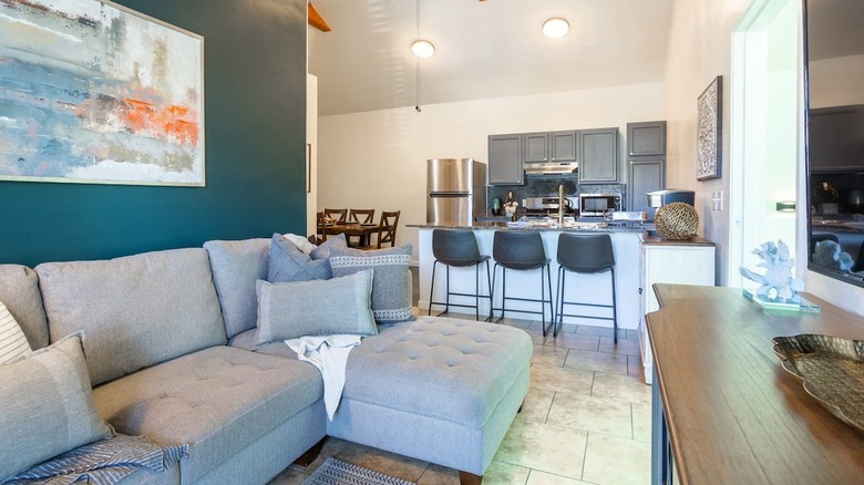 teal walls and gray couch 