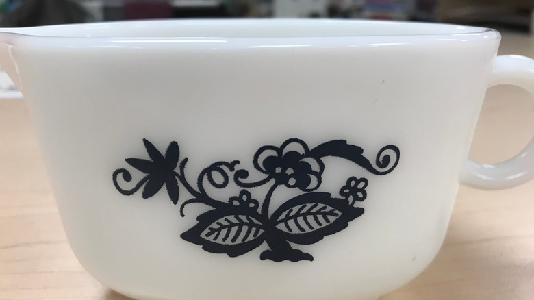 A 'Old Town Blue' Pyrex gravy boat, white with a black design.