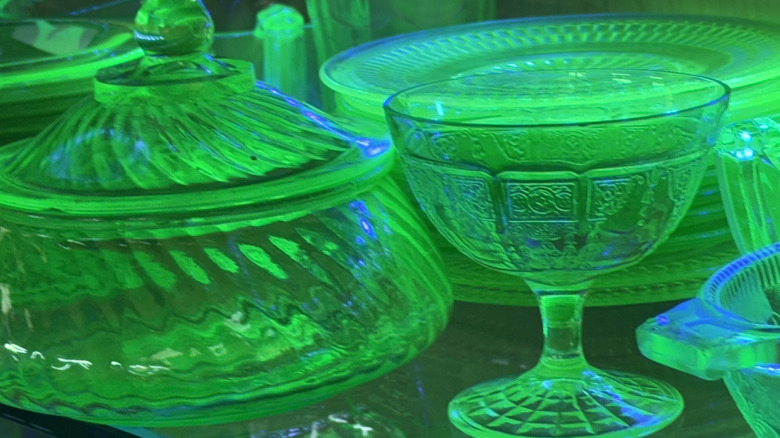 An antique shop displays a few pieces of Depression-era uranium glass, which glows under a black light.