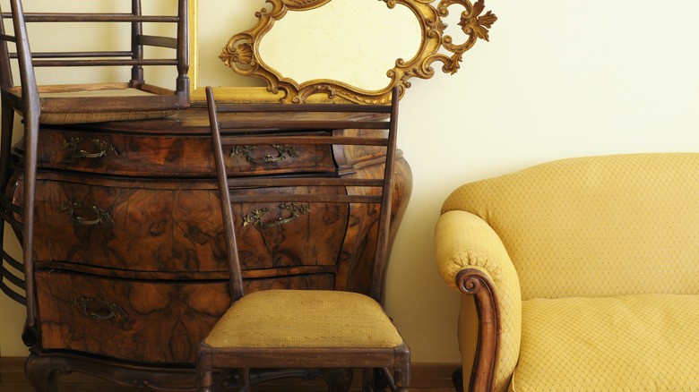 Antique dresser with gilt mirror and chair stacked on top