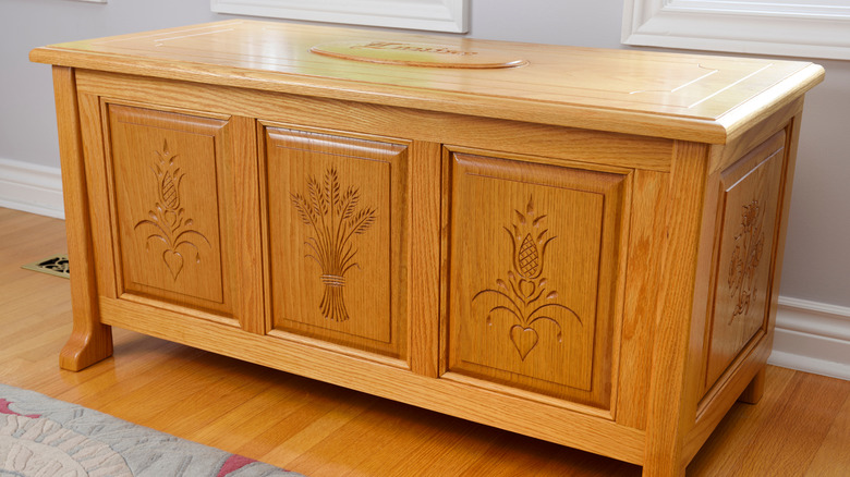 Honey-toned hope chest againt a soft gray wall