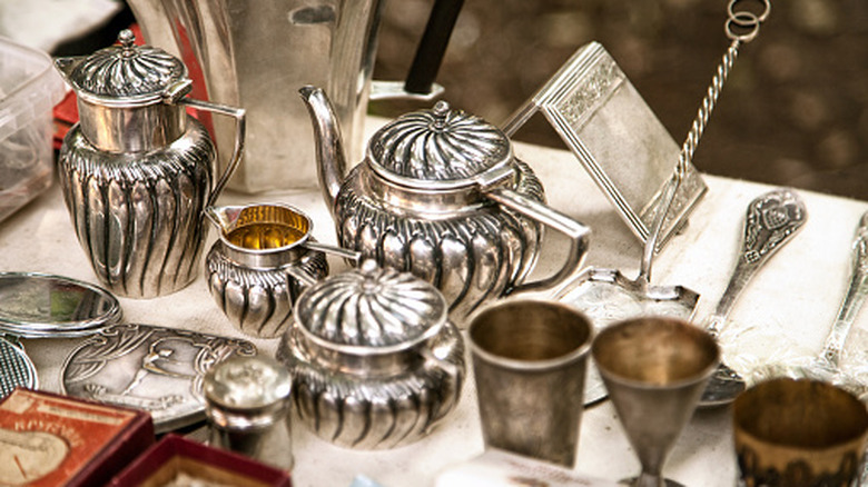 Antique silver serving items arranged on a table