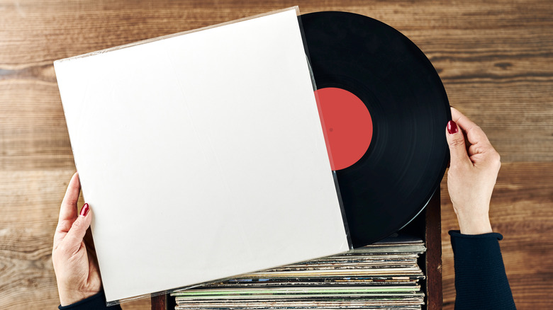Person looking at a box of vinyl records