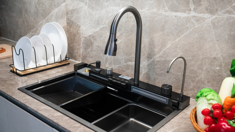 A modern, black kitchen faucet and sink