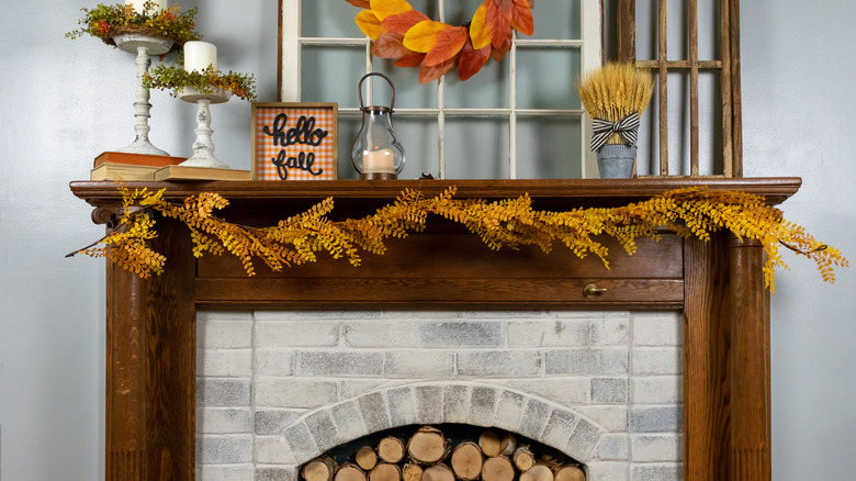 fireplace mantel decorated for fall