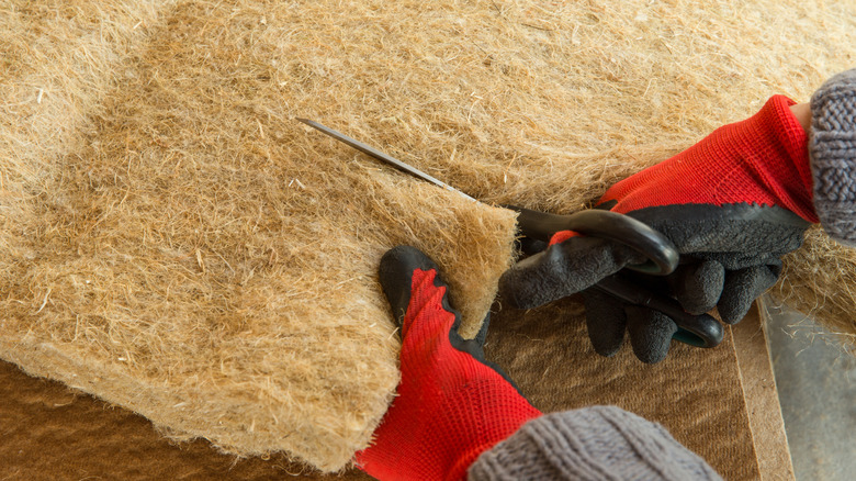 Cutting a natural hemp insulation panel during installation