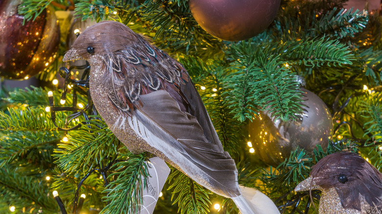 close up shot of brown and gray bird ornaments on a Christmas tree