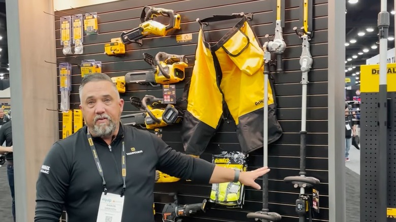 DeWalt rep showing DeWalt pole hedge trimmers at a display