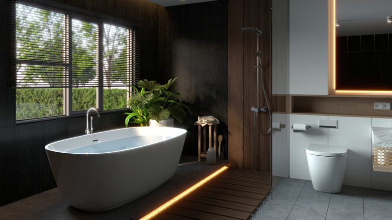 Warm wood bathroom with freestanding tub and shower