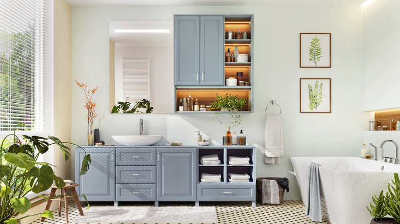 Bathroom with blue vanity and wall cupboard