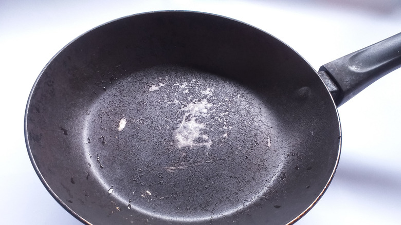 A scratched and peeling nonstick pan